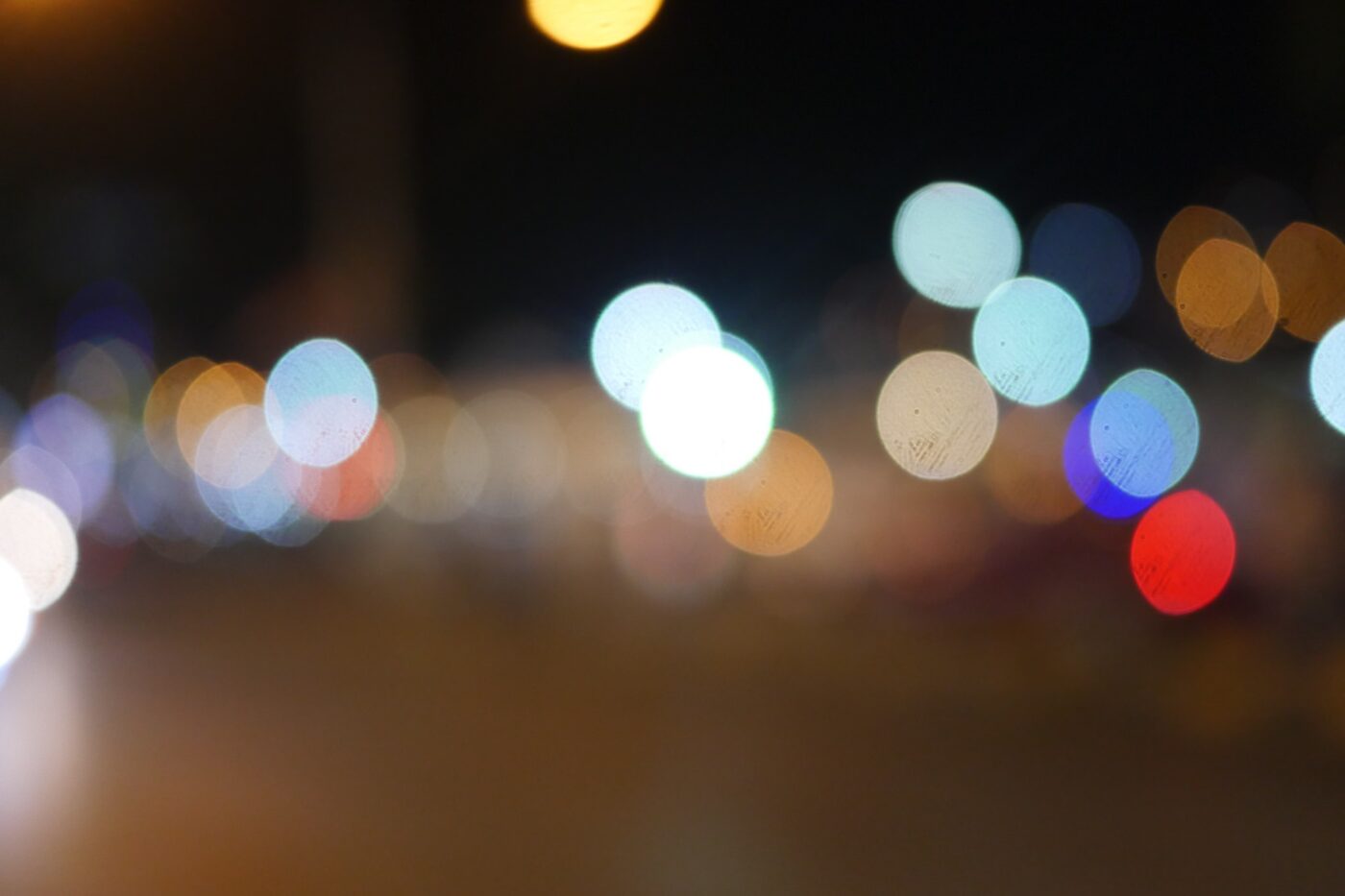 Abstract image of colorful city lights blurred at night.- nbcreations