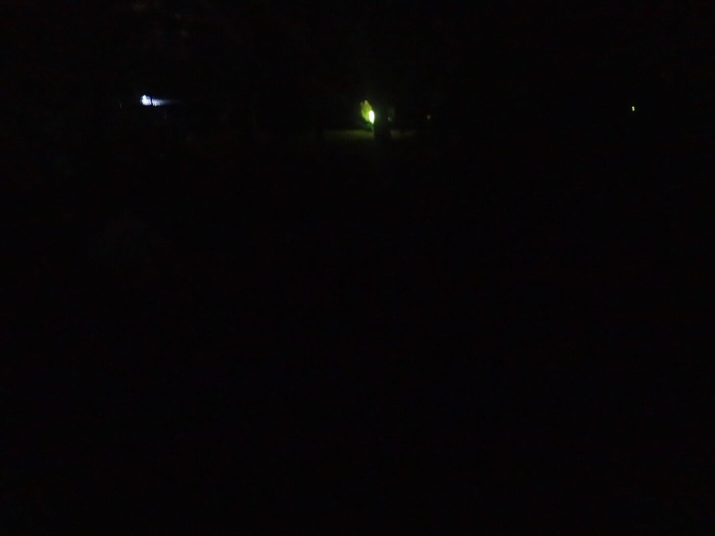 Night scene with faint greenish light glowing in the darkness – minimal and mysterious nocturnal image - nbcreations