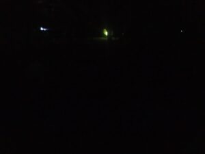Night scene with faint greenish light glowing in the darkness – minimal and mysterious nocturnal image - nbcreations