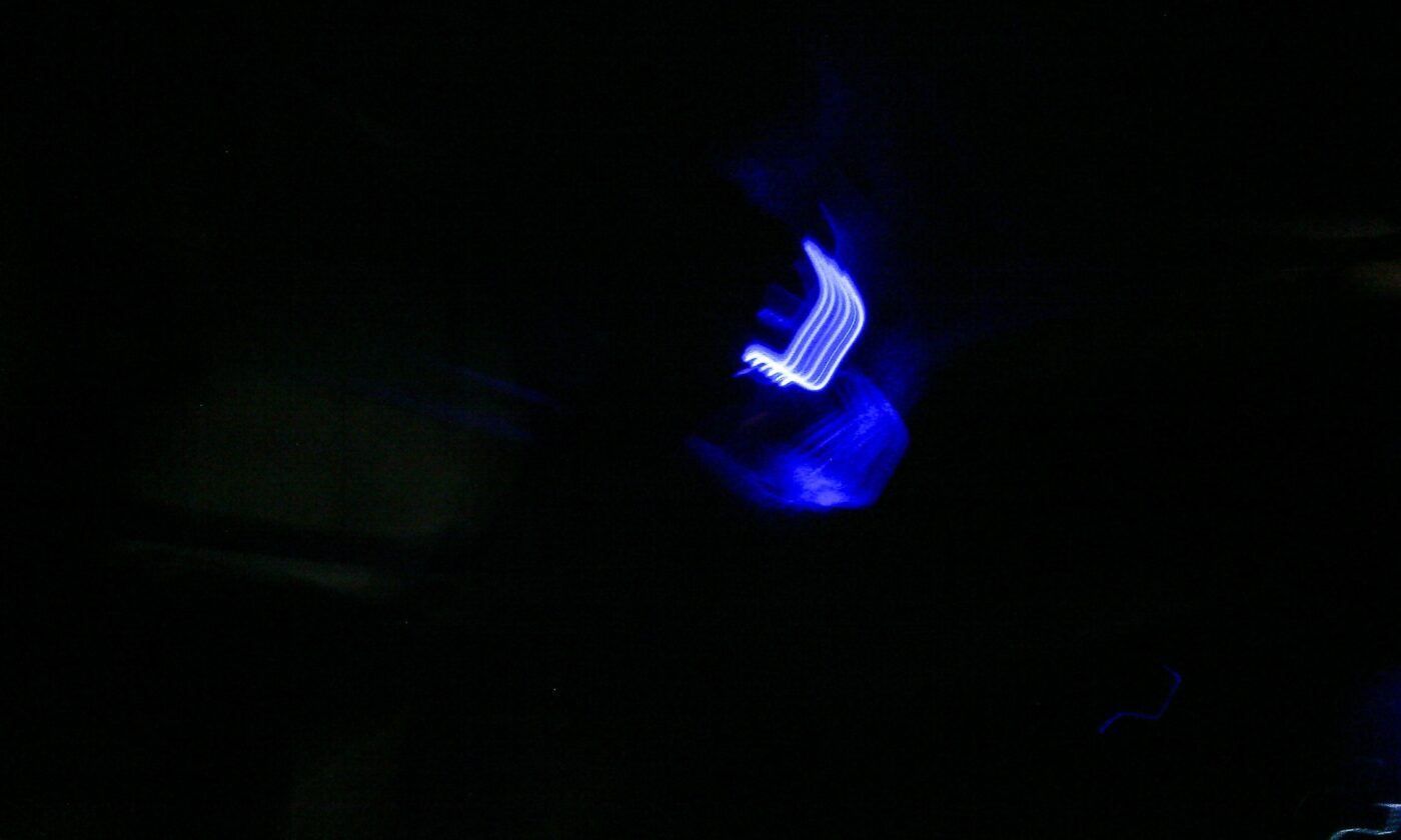 Abstract photo with blue neon light on a black background. - nbcreations