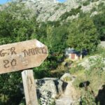 Wooden trail signpost in scenic mountain landscape, GR20 Corsica NBCreations