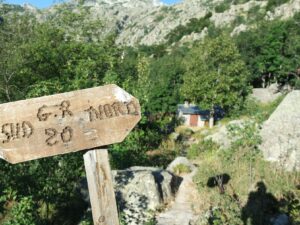 Wooden trail signpost in scenic mountain landscape, GR20 Corsica NBCreations